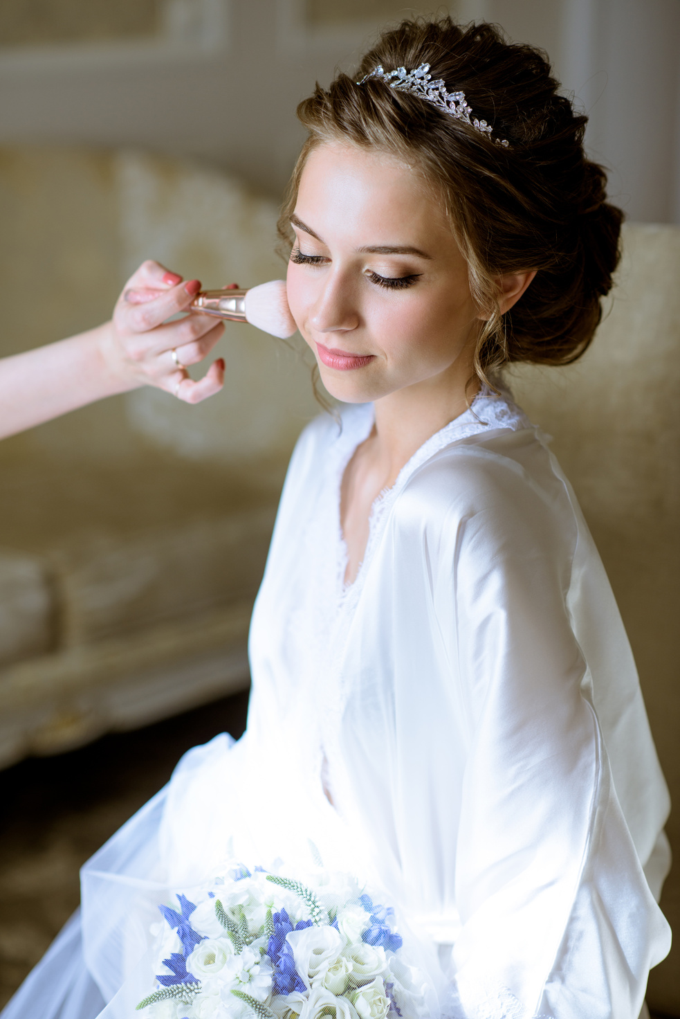 Wedding makeup artist making a make up for bride